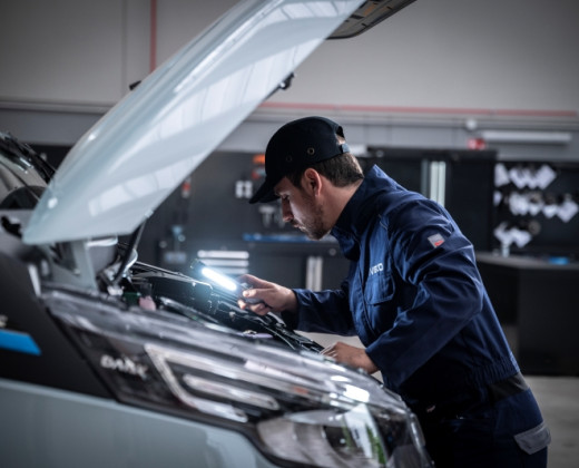 Mechanic looking at engine in garage